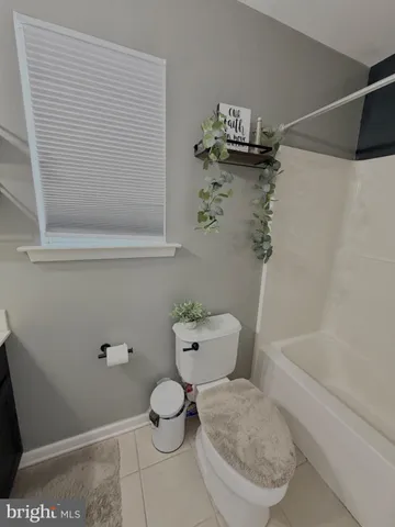 a bathroom with a sink mirror and toilet