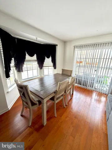 a dining room with furniture a rug and wooden floor