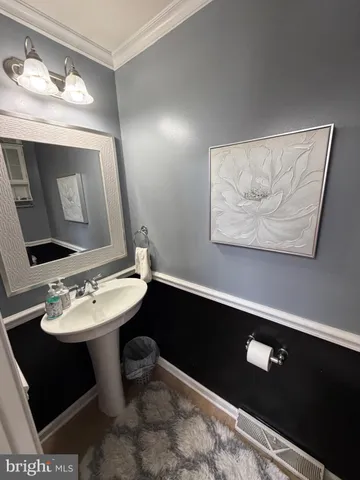 a bathroom with a sink vanity and a mirror