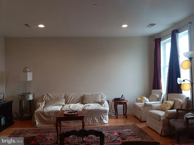 a living room with furniture and painting on the wall