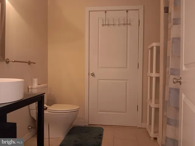 a bathroom with a toilet a sink and shower