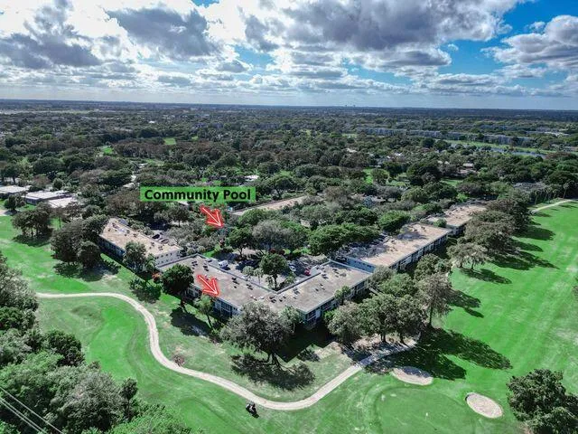 an aerial view of residential houses with outdoor space and trees