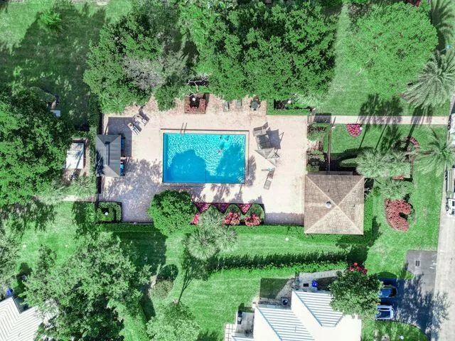 an aerial view of a house with garden space and street view