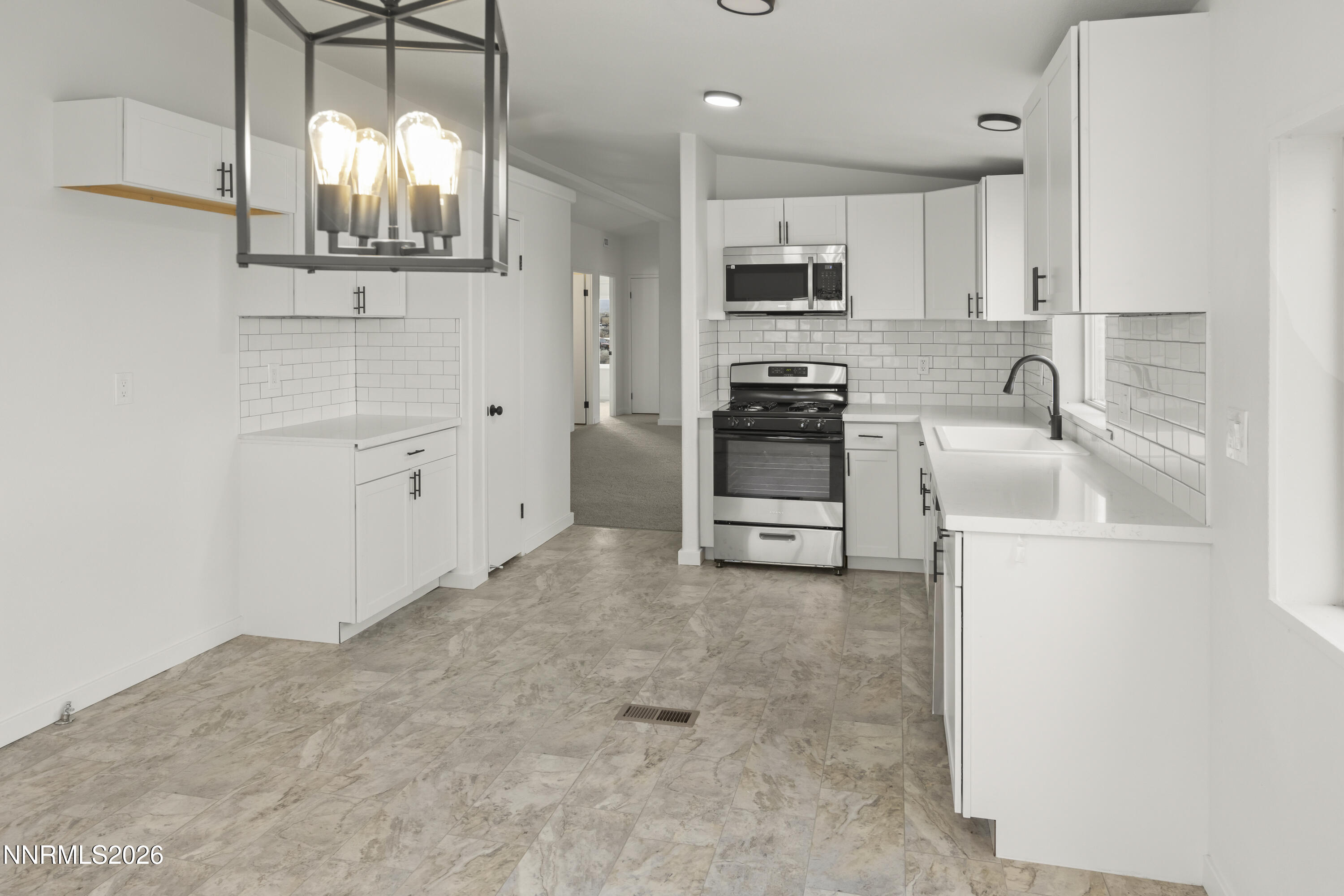 3225 Antelope Street Silver Springs, NV 89429 - Photo 11 of 39 a kitchen with white cabinets and stainless steel appliances