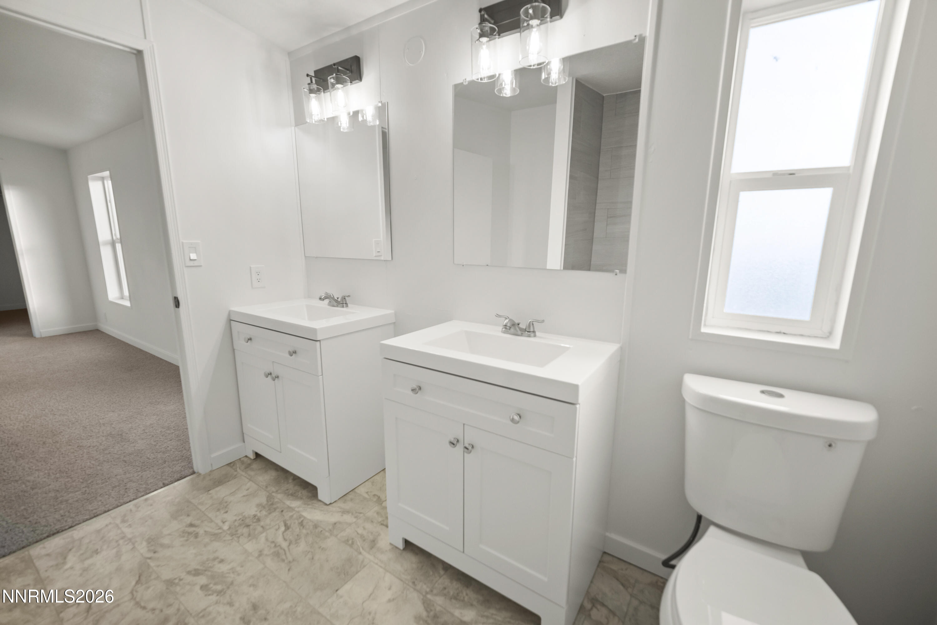3225 Antelope Street Silver Springs, NV 89429 - Photo 22 of 39 a bathroom with a toilet sink and mirror
