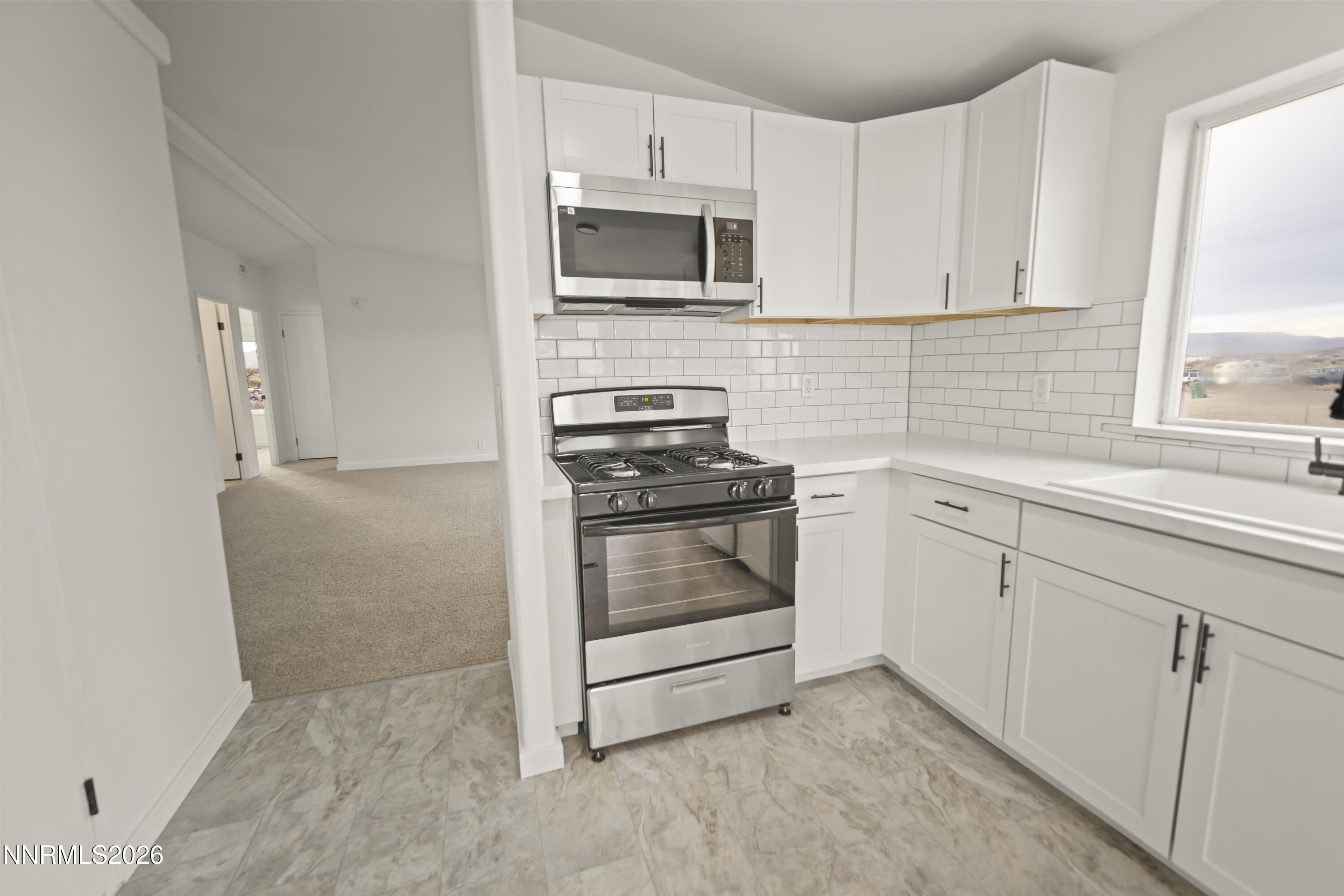 3225 Antelope Street Silver Springs, NV 89429 - Photo 3 of 39 a kitchen with white cabinets and appliances