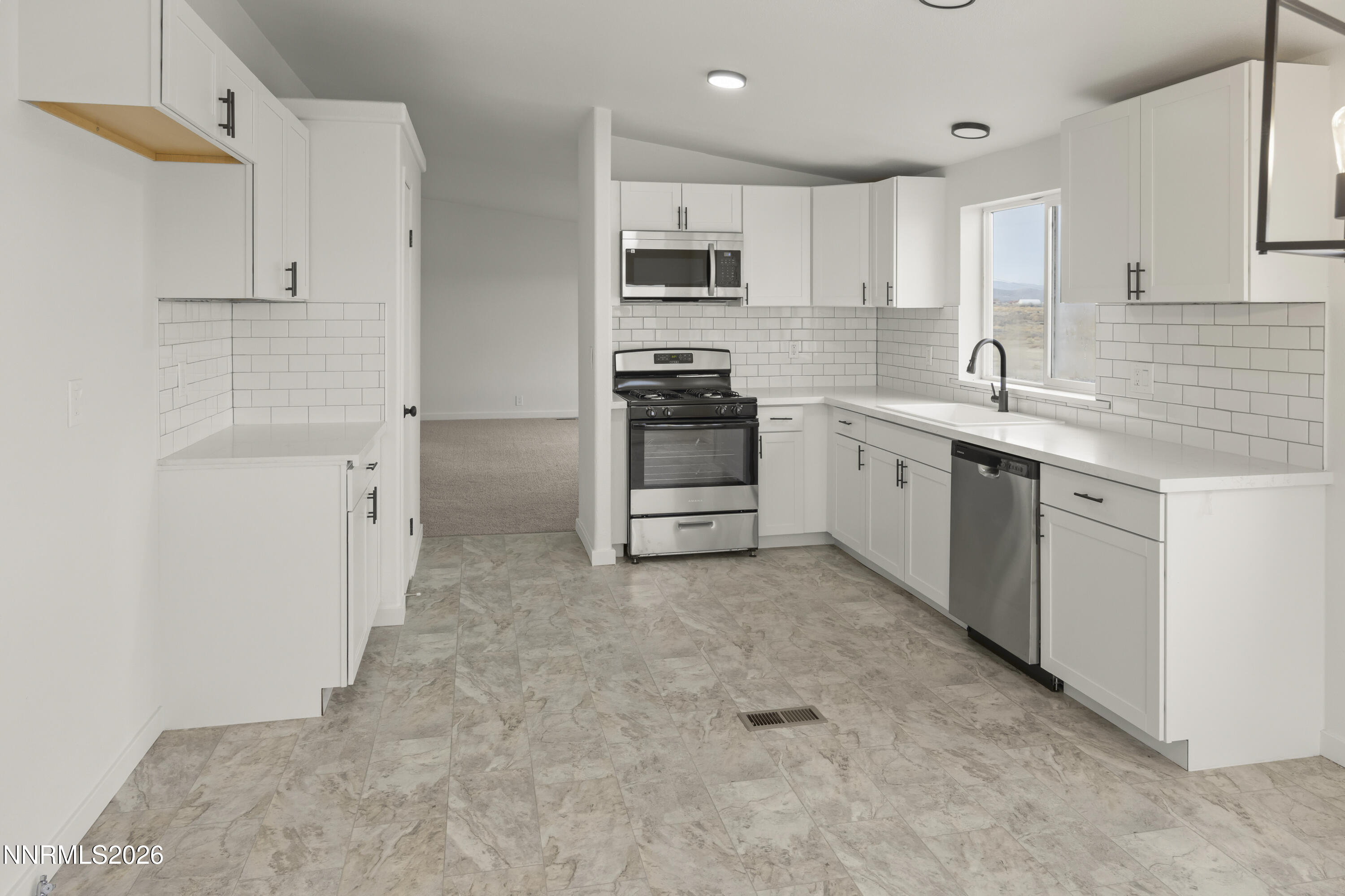 3225 Antelope Street Silver Springs, NV 89429 - Photo 10 of 39 a kitchen with granite countertop a sink stove and refrigerator