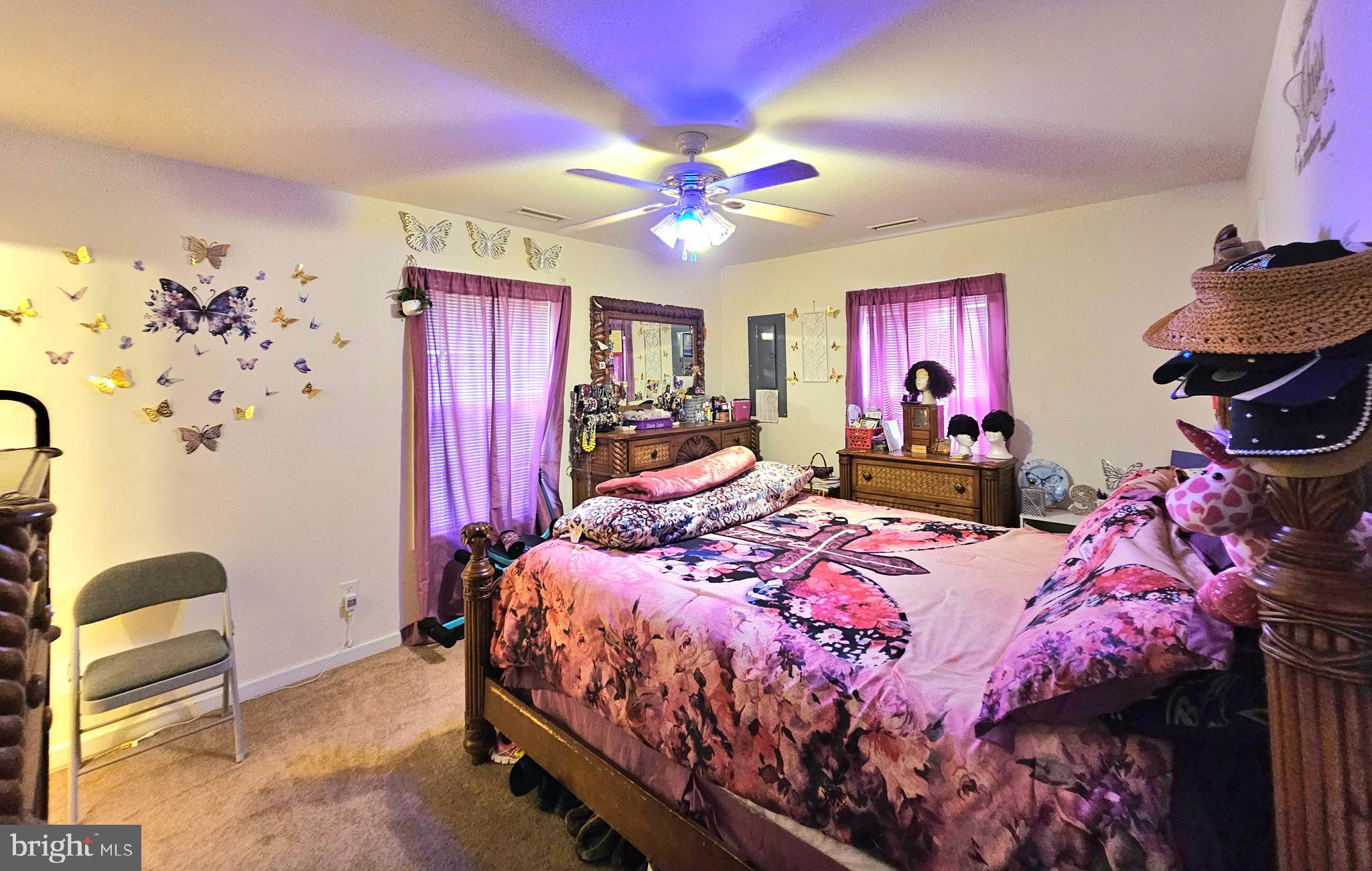 8339 Upper Hill Road Westover, MD 21871 - Photo 13 of 20 a bedroom with a bed purple white bedspread and pink walls