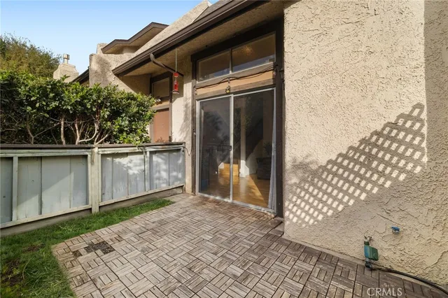 a backyard of a house with wooden floor and fence