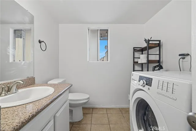 a view of a bathroom with washing machine and a sink