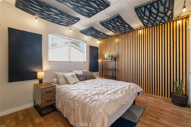 a bedroom with a bed next to a window