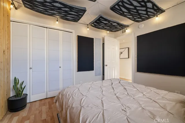 a spacious bedroom with a bed and a potted plant