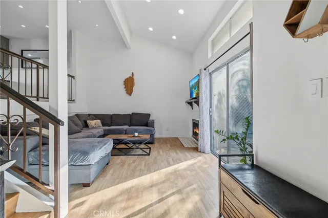 a living room with furniture and a potted plant