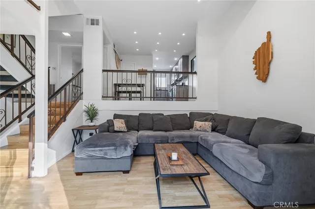 a living room with furniture and a wooden floor