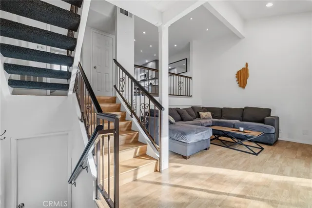 a living room with furniture and stairs