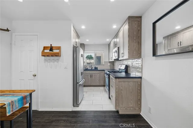 a kitchen with stainless steel appliances granite countertop a refrigerator and a stove top oven