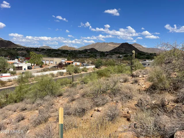 a view of a houses with mountains in the background