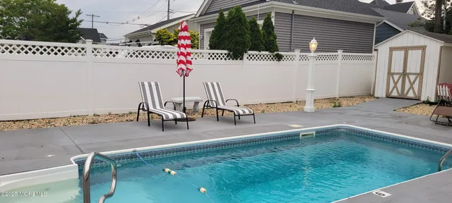 a view of a chairs and table in backyard
