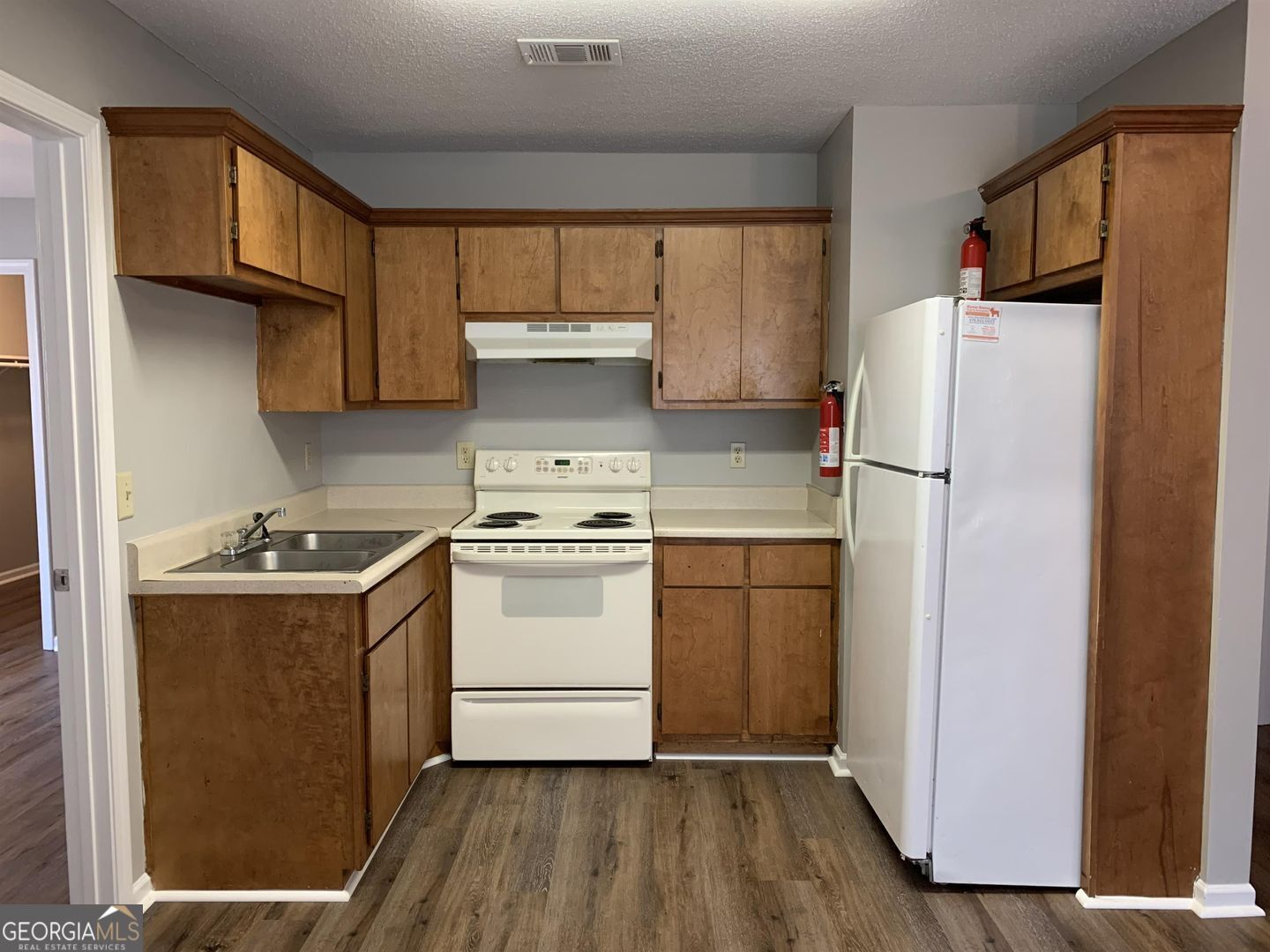 708 Green Street, Unit B Fort Valley, GA 31030 - Photo 3 of 12 a kitchen with a stove a refrigerator and a sink