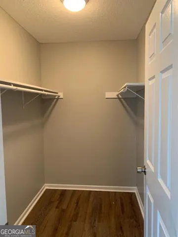 a view of a room with wooden floor