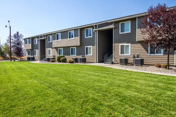 a front view of a house with a yard table and chairs