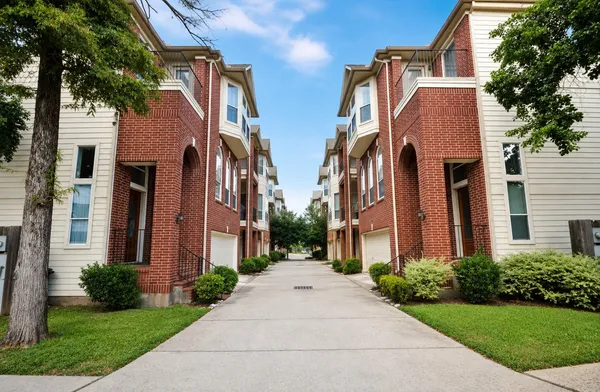 a view of a brick building next to a yard