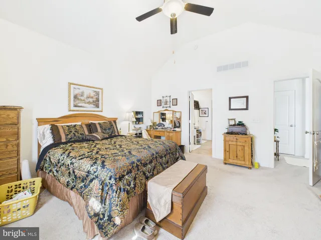 a bedroom with a bed and dresser