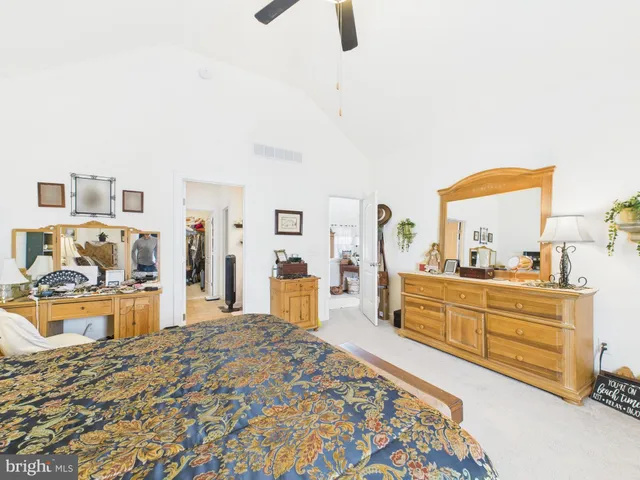 a large bedroom with a bed and a large window