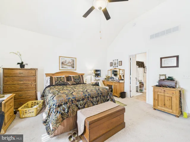 a bedroom with a bed and a couch