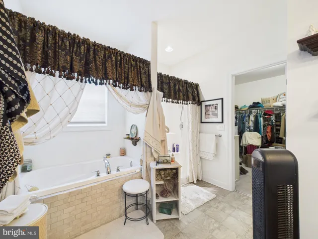 a bathroom with a bathtub a sink a toilet and a shower