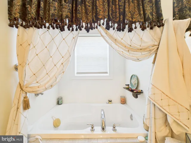 a bathroom with a bathtub and shower