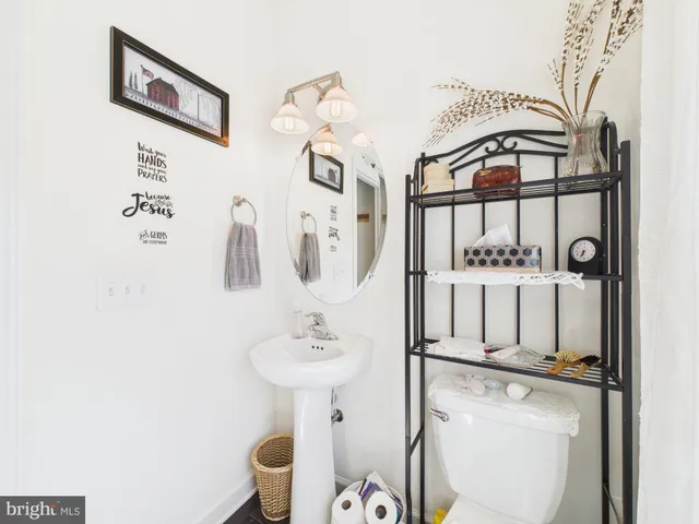 a bathroom with a sink toilet and mirror