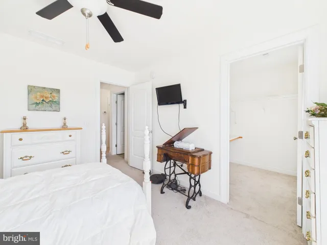 a bedroom with a bed window and couch