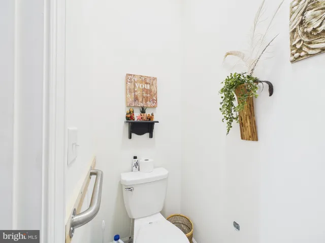 a white toilet sitting next to a bath tub