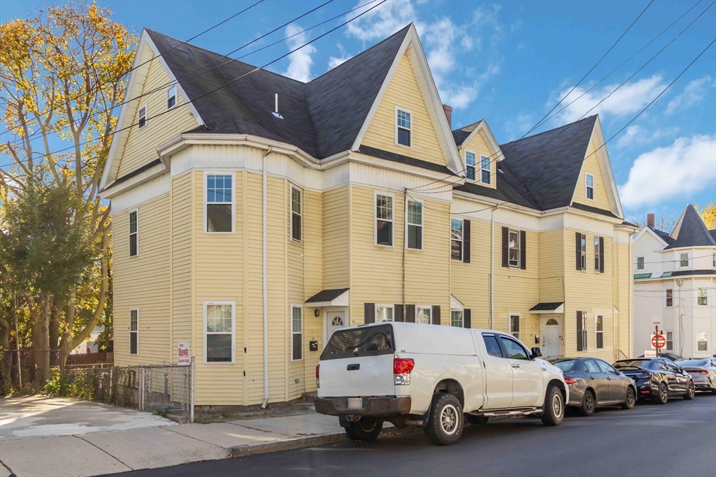 a view of a white car parked in front of a house