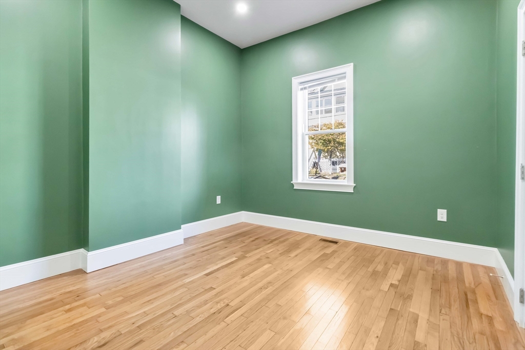 51 Mansfield Street, Unit 51 Everett, MA 02149 - Photo 12 of 19 a view of an empty room with wooden floor and a window