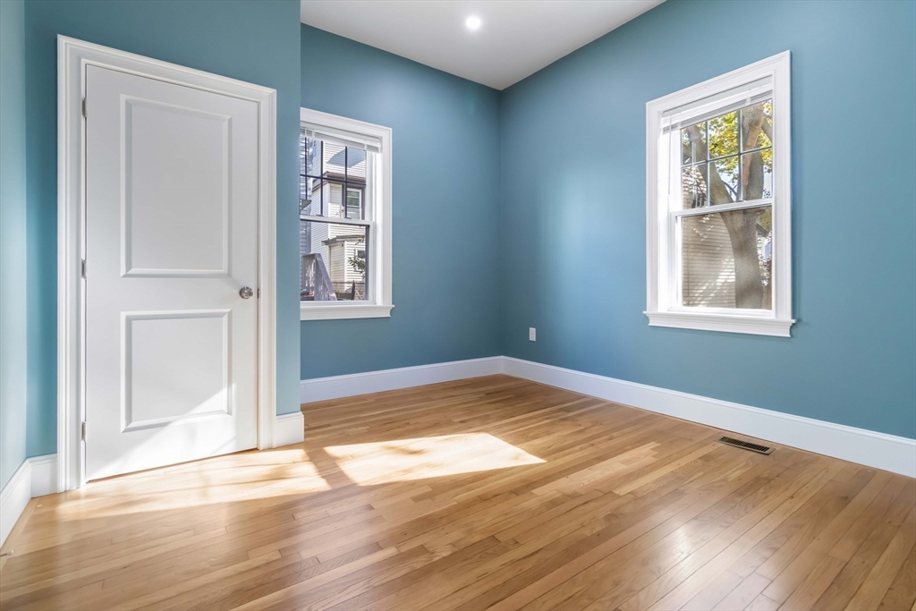 51 Mansfield Street, Unit 51 Everett, MA 02149 - Photo 13 of 19 a view of empty room with wooden floor and fan