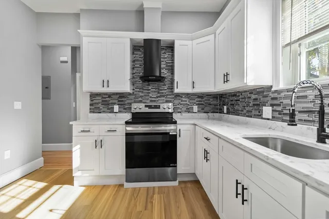 a kitchen with stainless steel appliances granite countertop a stove and a sink