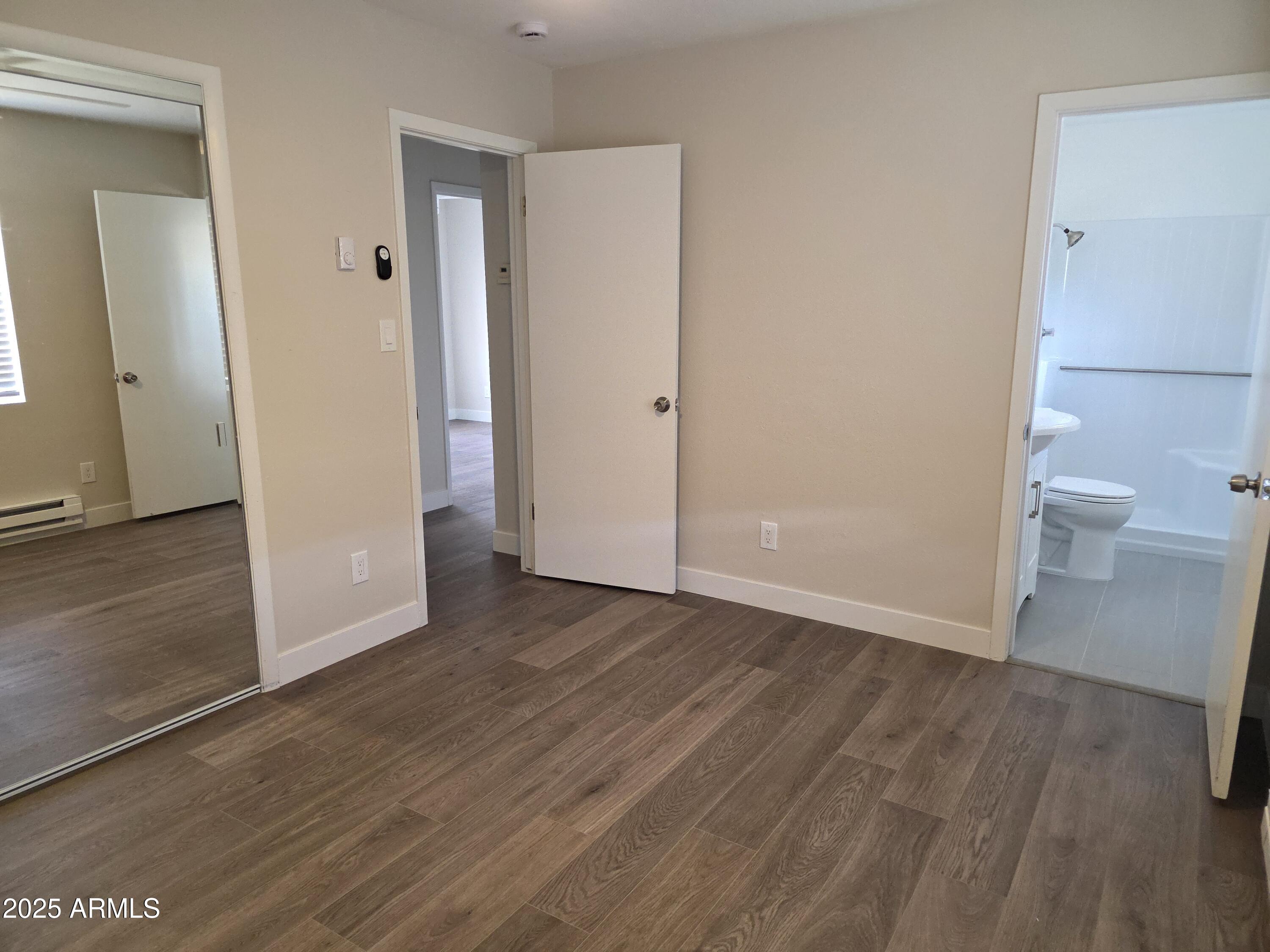 731 Elm Lane Eagar, AZ 85925 - Photo 11 of 26 wooden floor in an empty room and a bathroom