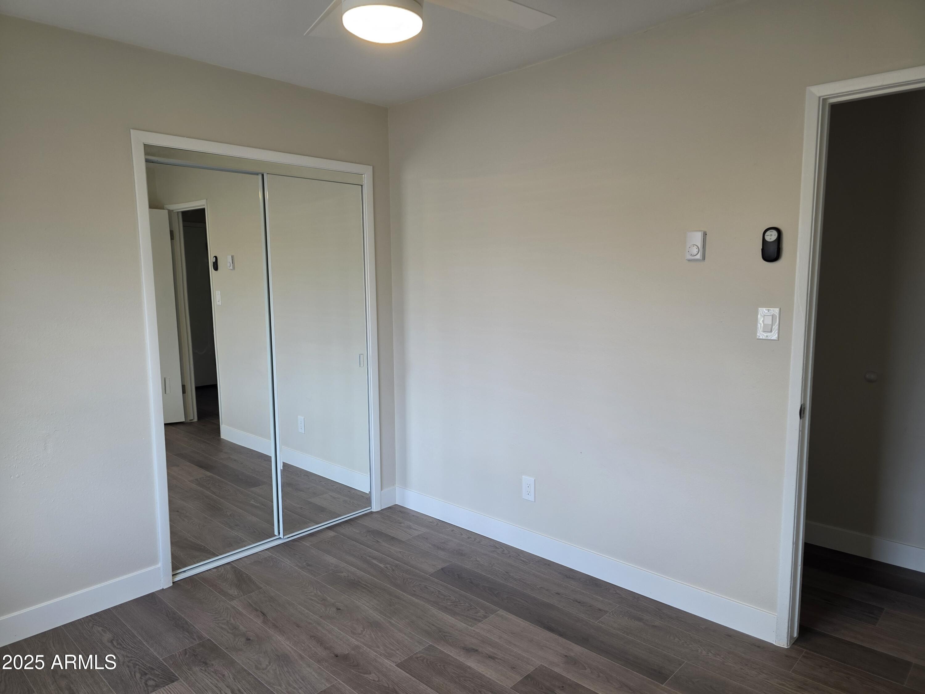 731 Elm Lane Eagar, AZ 85925 - Photo 14 of 26 an empty room with wooden floor and closet