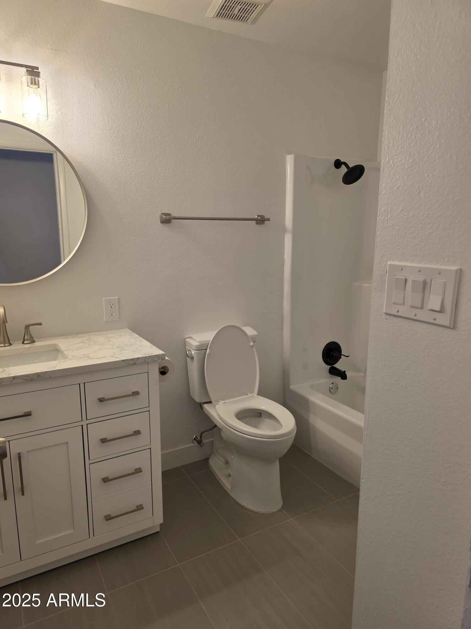 731 Elm Lane Eagar, AZ 85925 - Photo 15 of 26 a bathroom with a toilet a sink a vanity and mirror