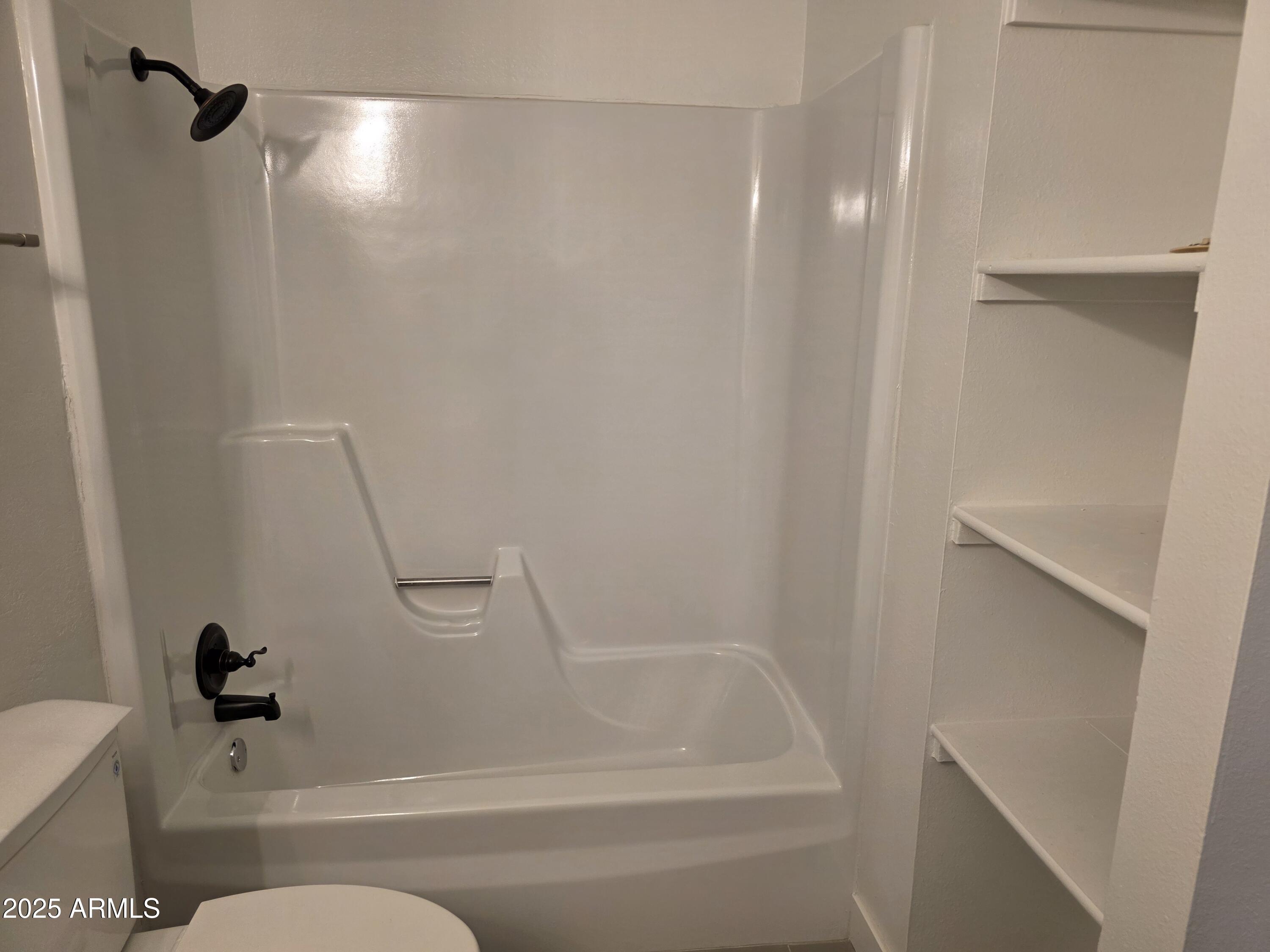 731 Elm Lane Eagar, AZ 85925 - Photo 16 of 26 a bathroom with a granite countertop bathtub shower and toilet