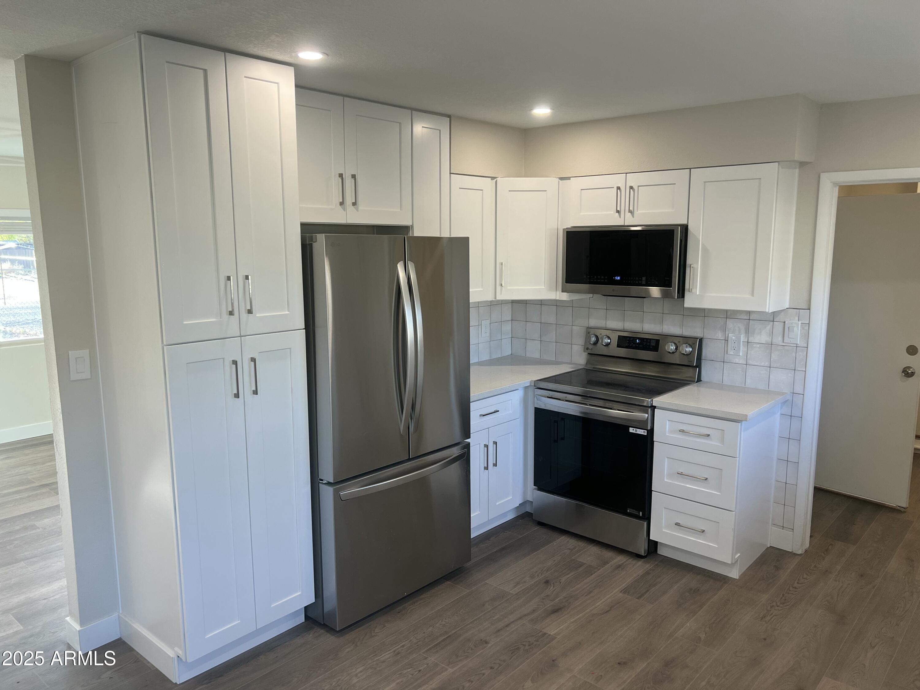 731 Elm Lane Eagar, AZ 85925 - Photo 8 of 26 a kitchen with stainless steel appliances a refrigerator a stove top oven a sink and dishwasher