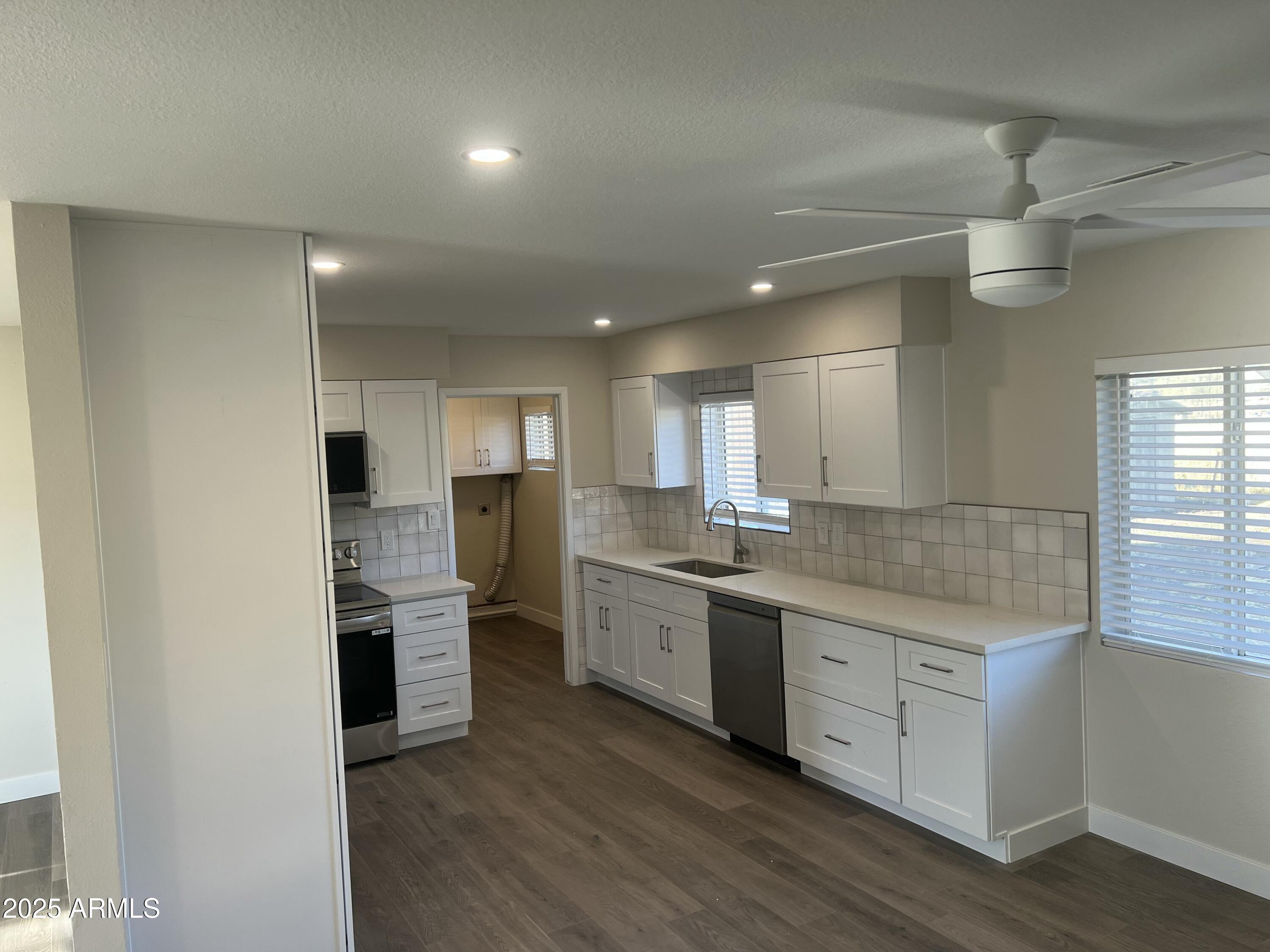 731 Elm Lane Eagar, AZ 85925 - Photo 9 of 26 a large kitchen with stainless steel appliances granite countertop a stove and a sink