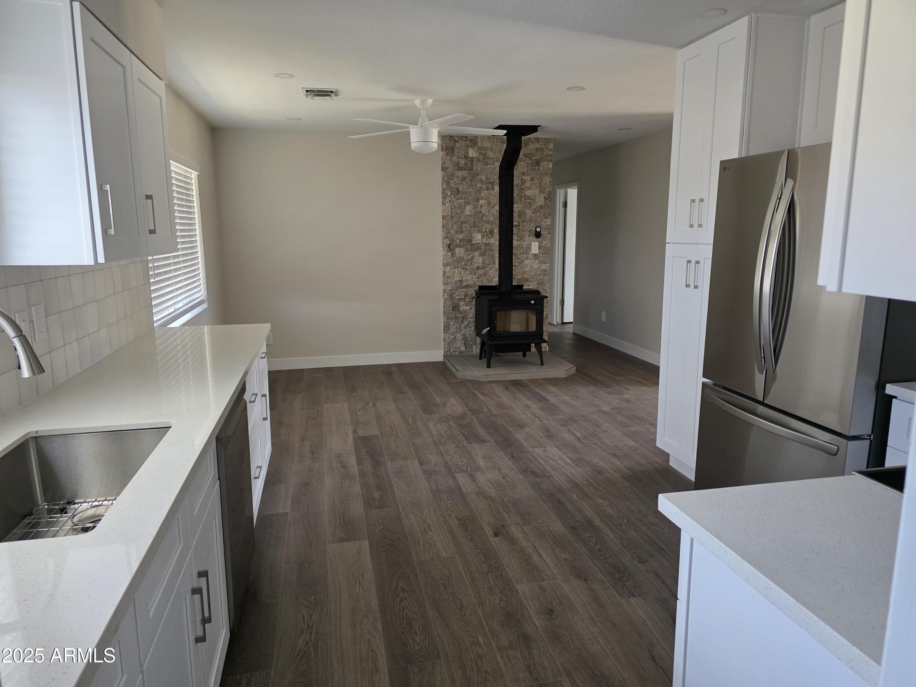 731 Elm Lane Eagar, AZ 85925 - Photo 10 of 26 a kitchen with a refrigerator and a sink
