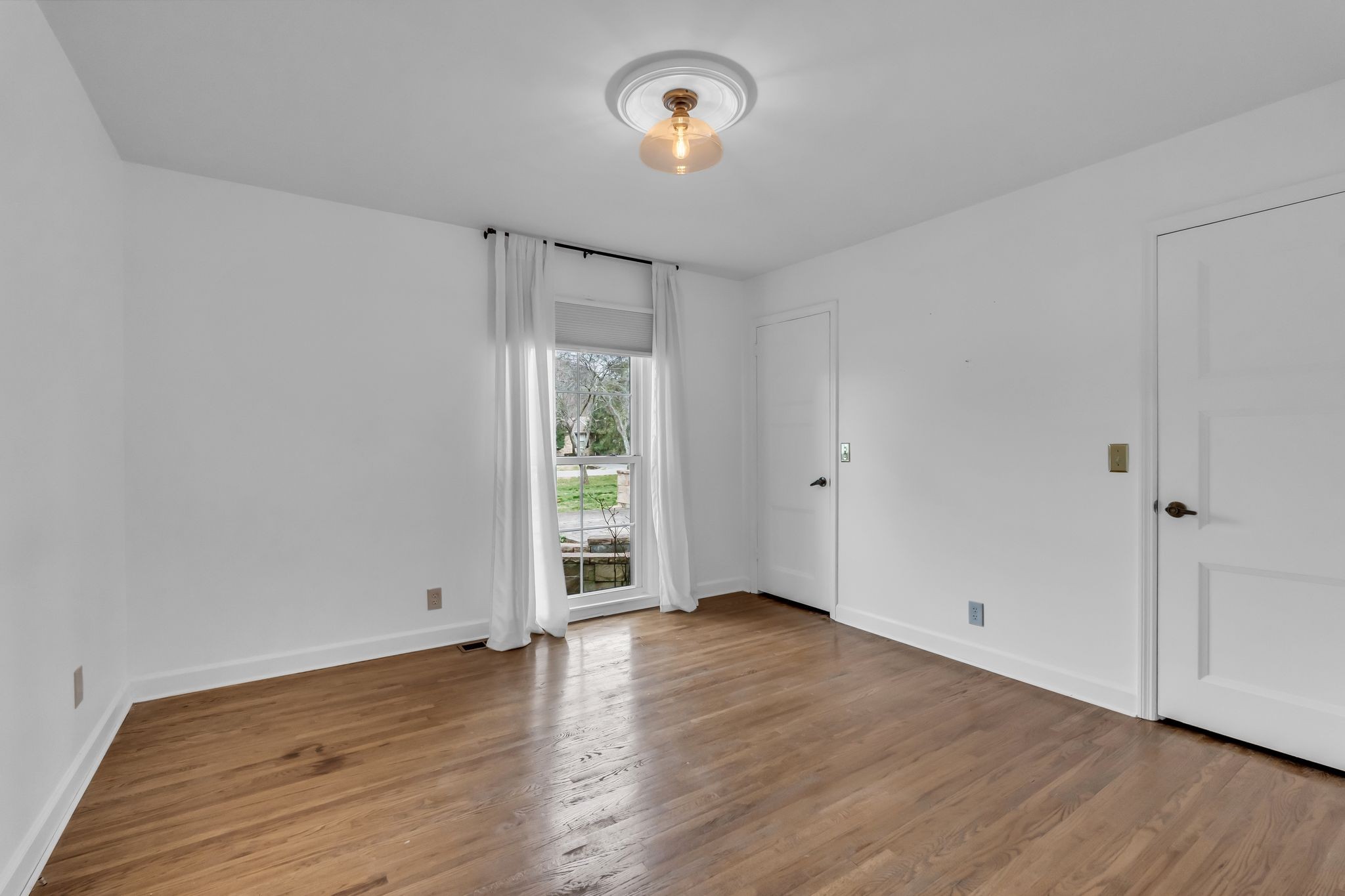 6307 Ramsgate Court Brentwood, TN 37027 - Photo 31 of 99 a view of an empty room with wooden floor and a window