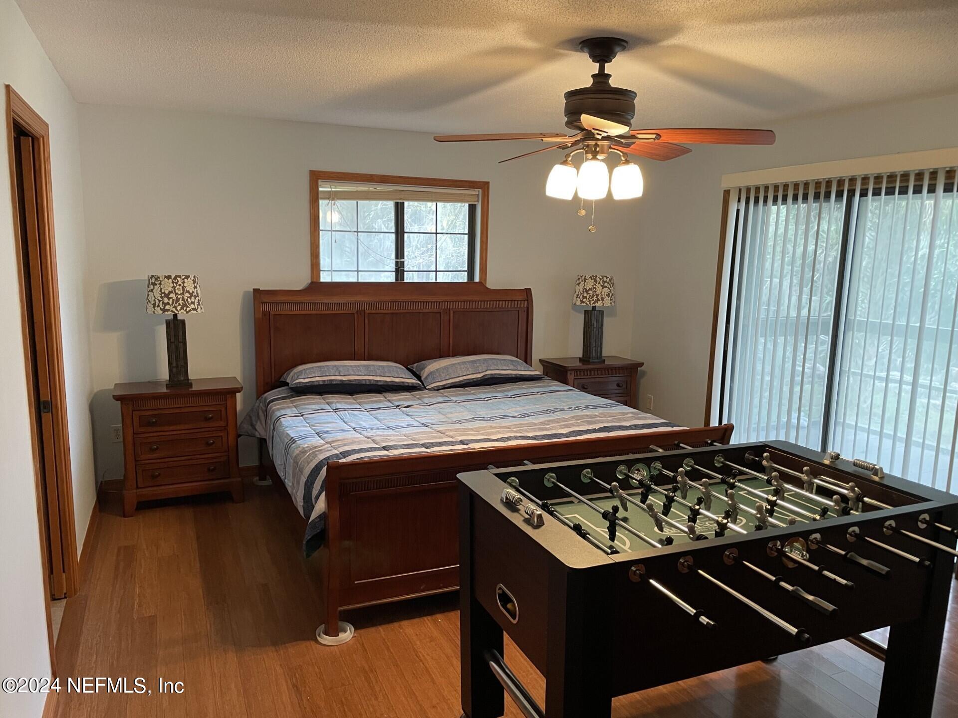 110 North Point Drive Georgetown, FL 32139 - Photo 11 of 28 a bedroom with a bed window and a chandelier