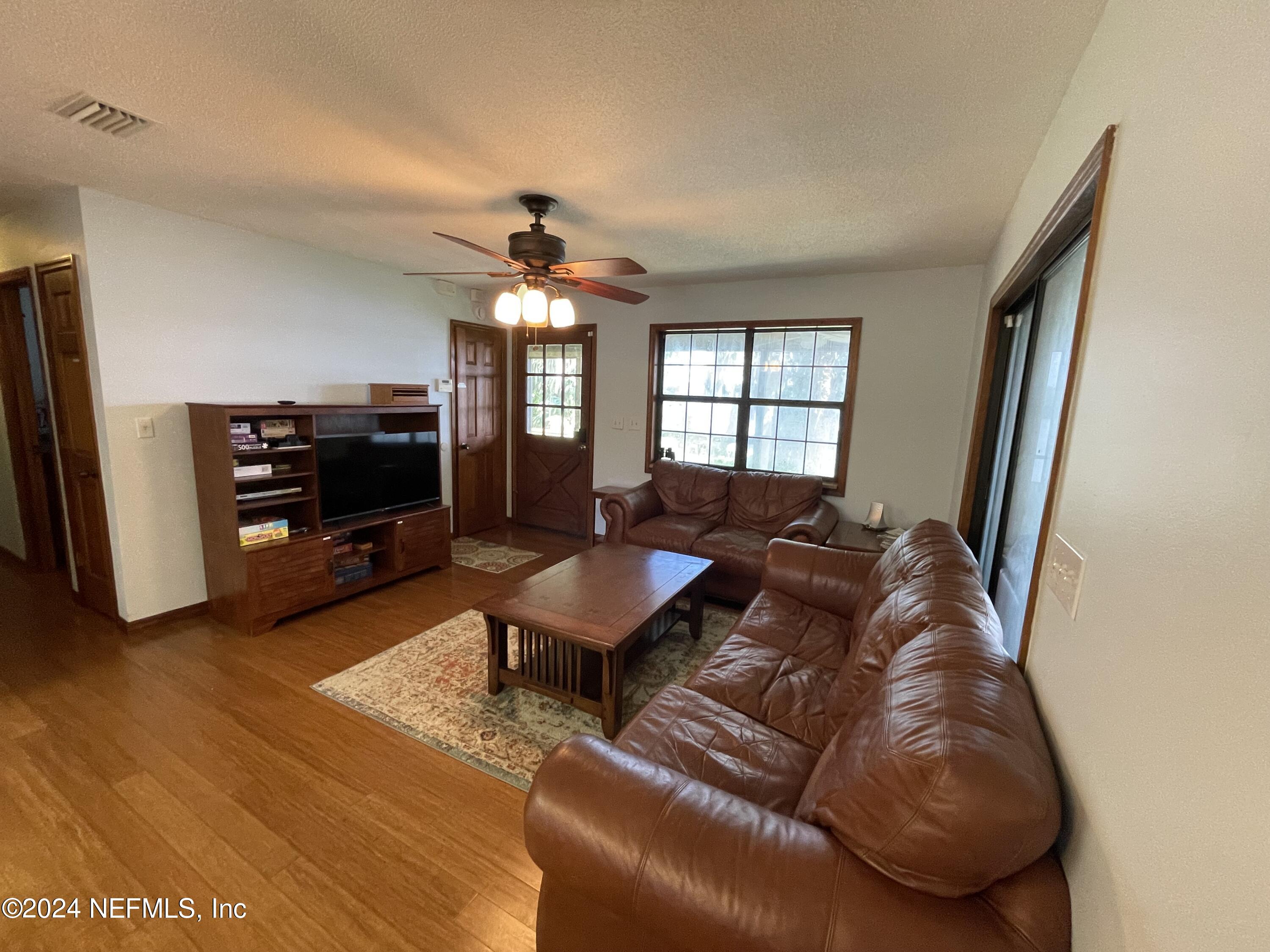 110 North Point Drive Georgetown, FL 32139 - Photo 6 of 28 a living room with furniture and a flat screen tv