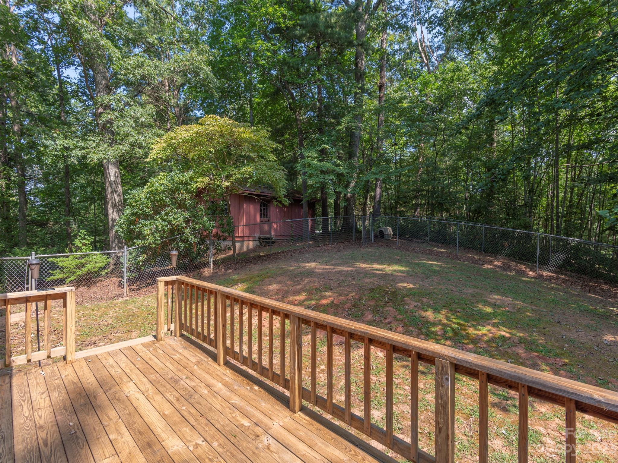167 Paradise Circle Clyde, NC 28721 - Photo 14 of 18 a view of balcony with wooden floor and fence