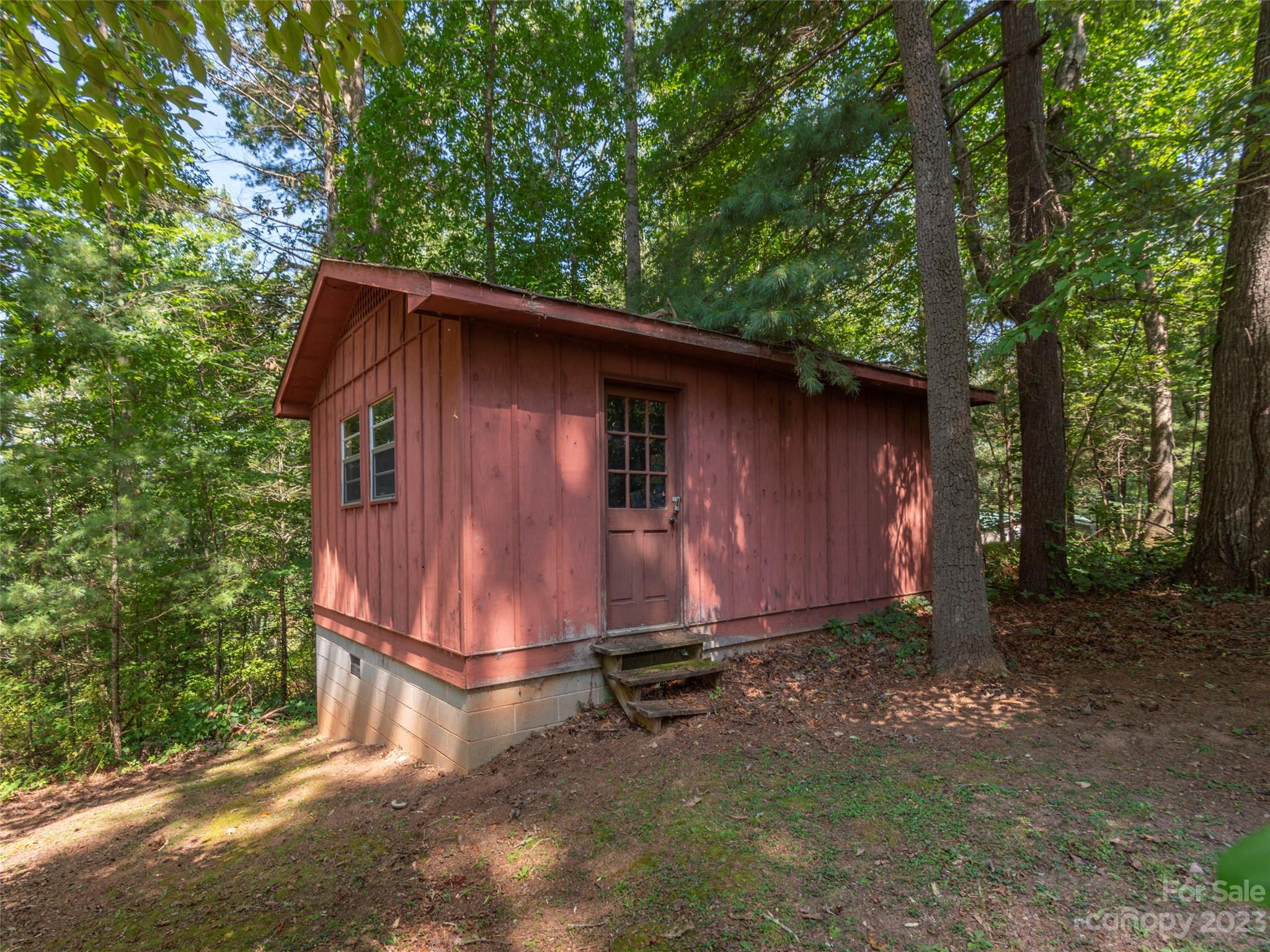 167 Paradise Circle Clyde, NC 28721 - Photo 16 of 18 a backyard of a house with lots of green space